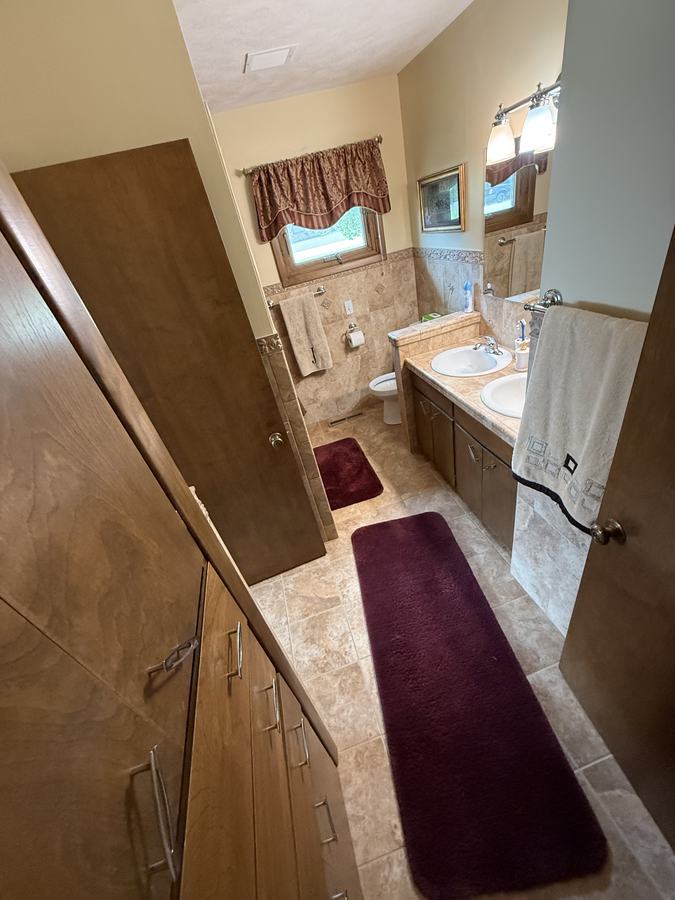 A clean hallway looking through to the bathroom.