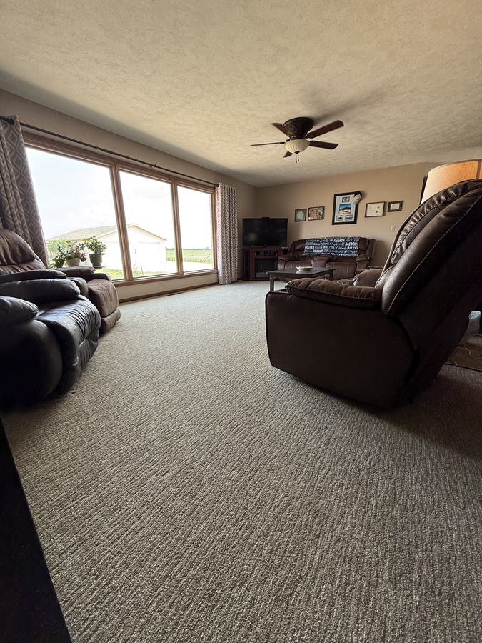 A tidy living room with the curtains open.